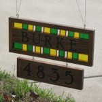 Wood and Stained Glass sign with light shining through